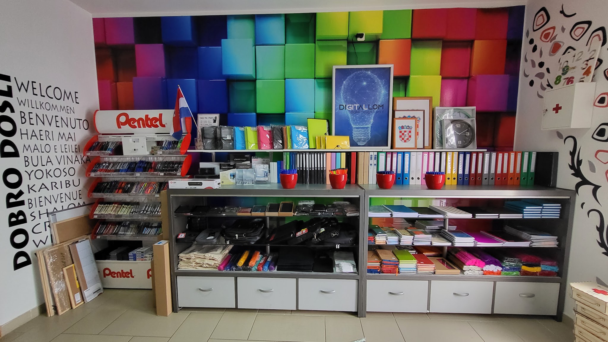 Colorful wall display and shelves of stationery inside Digital LOM.