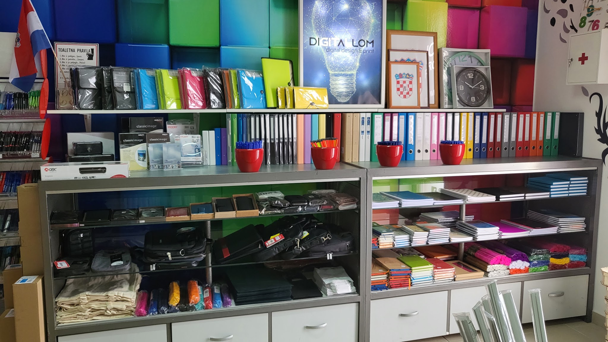 Colorful display wall above shelves and counters inside Digital LOM.